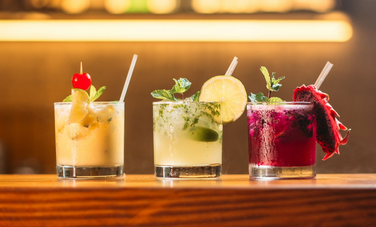 three clear glass cups with juice