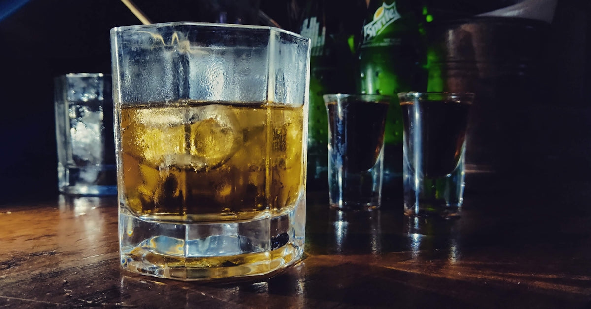 shot glass filled with yellow liquid
