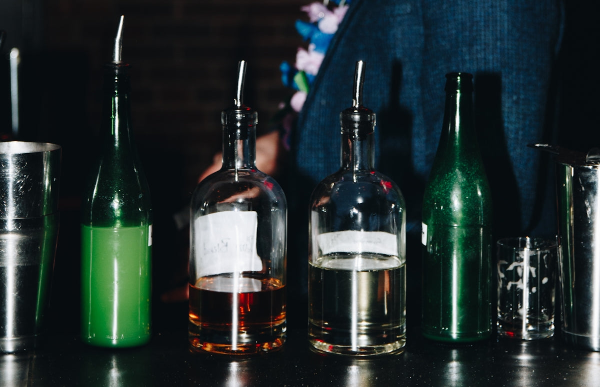 clear glass bottles on black table