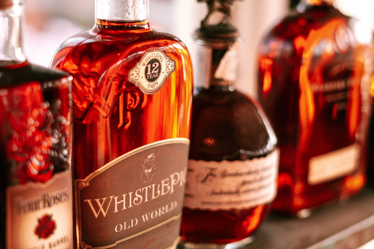 bottles of whiskey are lined up on a shelf