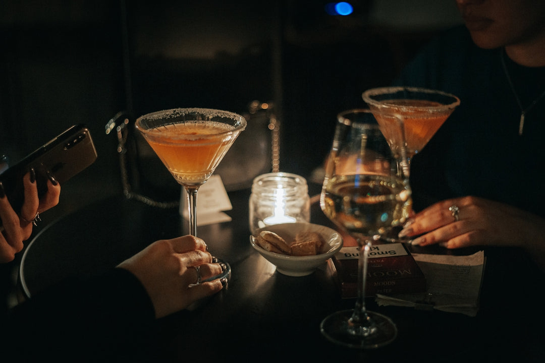 a group of people sitting at a table with drinks