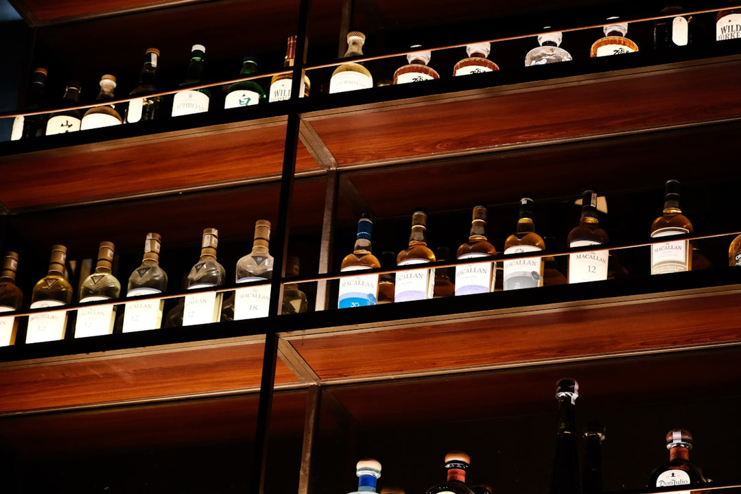 a shelf filled with lots of bottles of alcohol