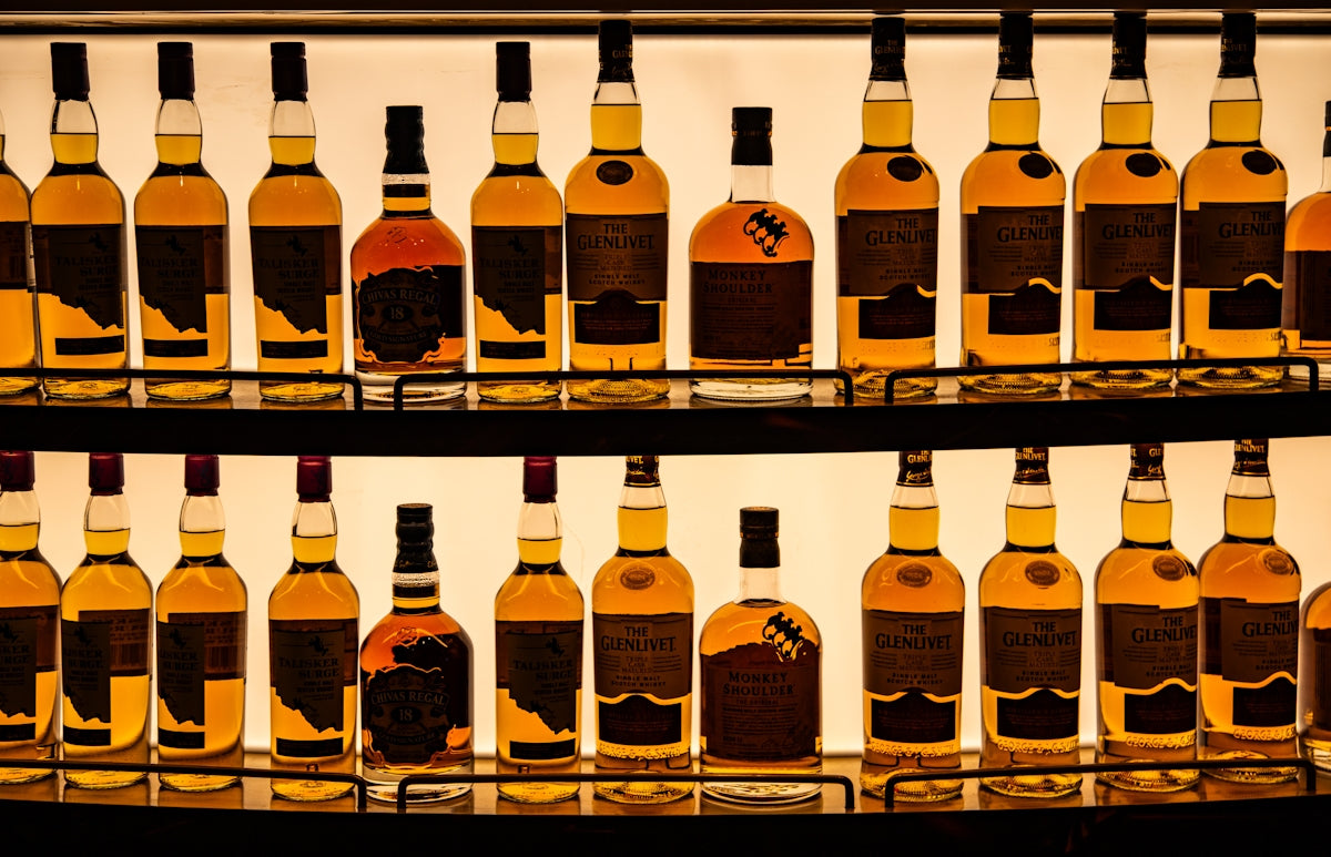 a display of bottles of various types of alcohol