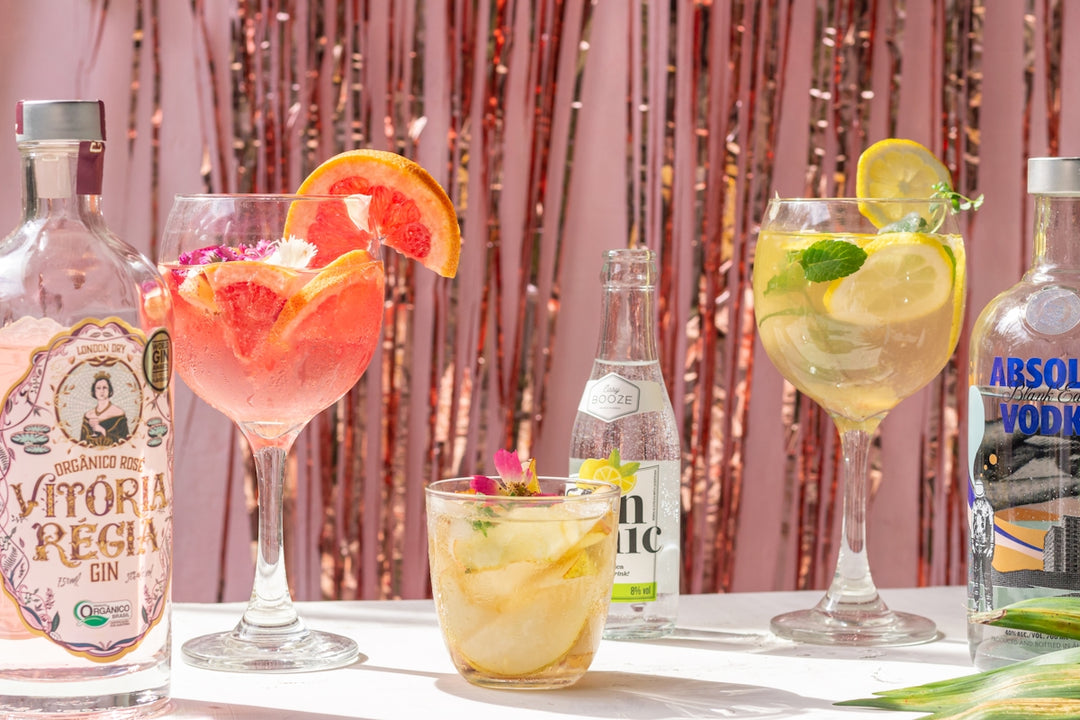 a table topped with glasses filled with different types of drinks