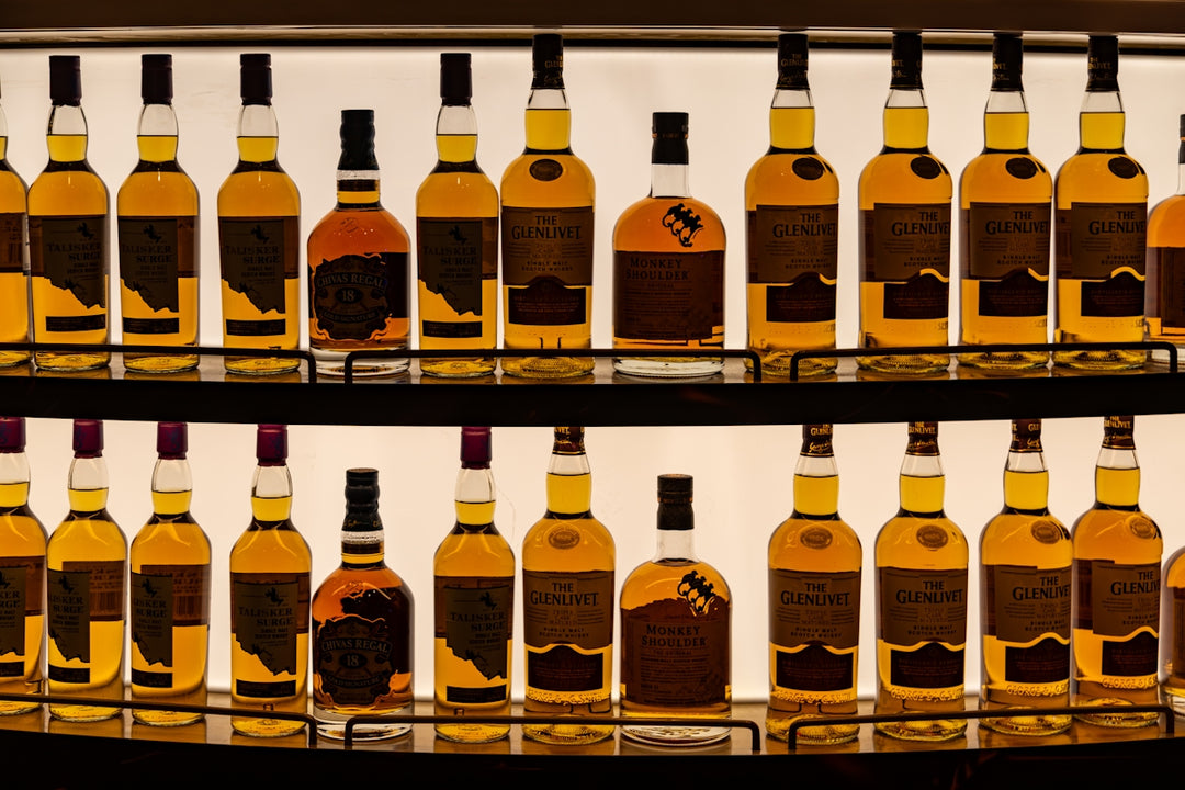 a display of bottles of various types of liquor
