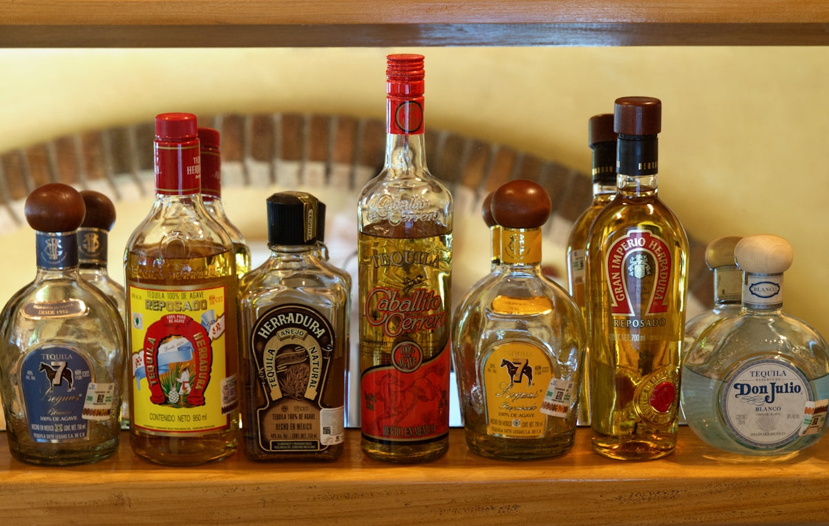A wooden shelf filled with bottles of liquor