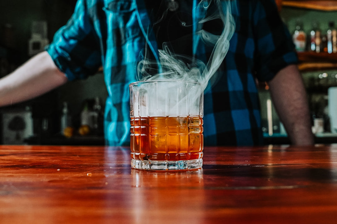 A man pouring a drink into a glass