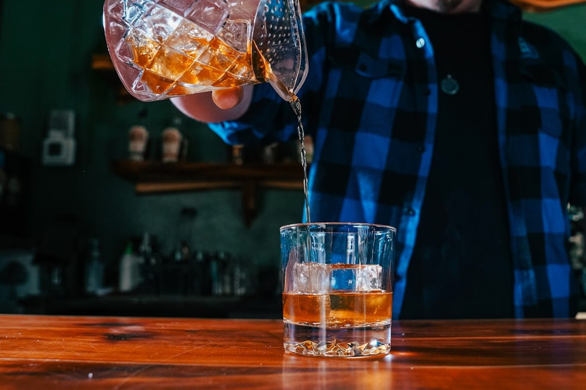 A man pouring a drink into a glass