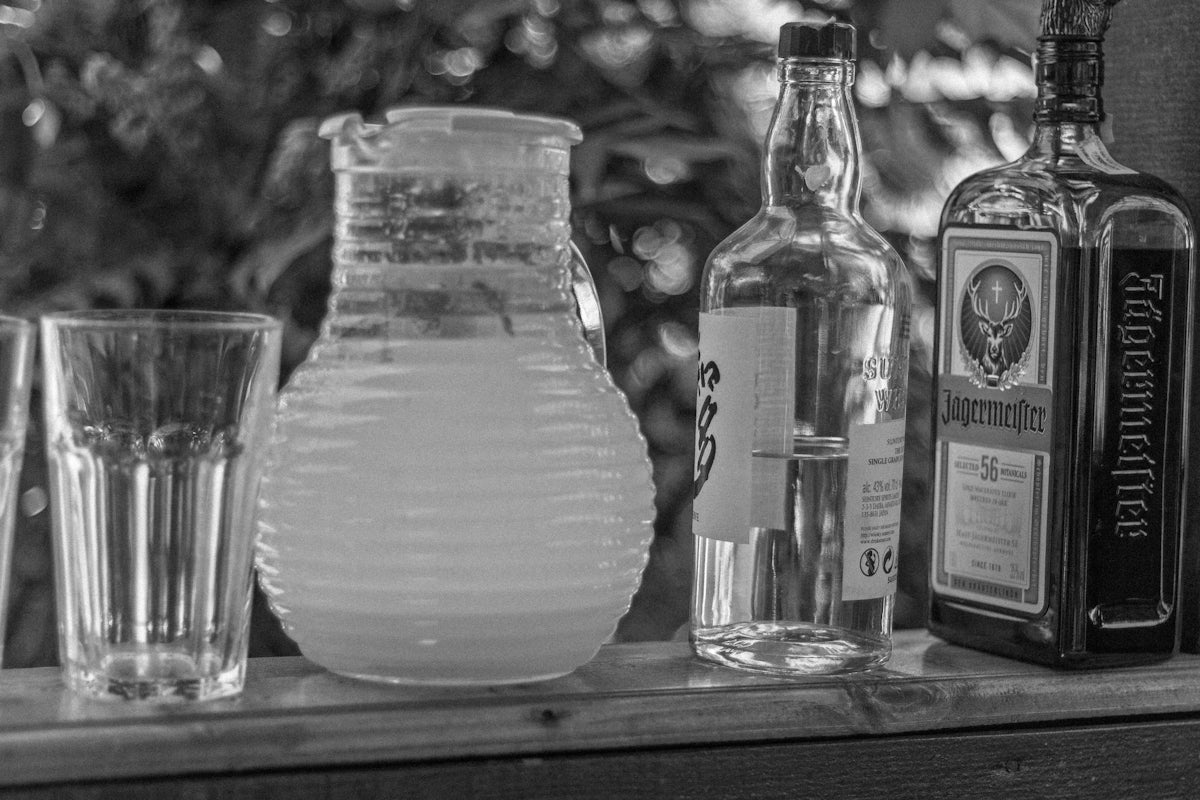 Drinks and alcohol are arranged on a bar.