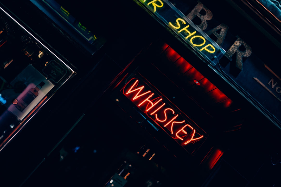 Neon signs for bar and whiskey at night